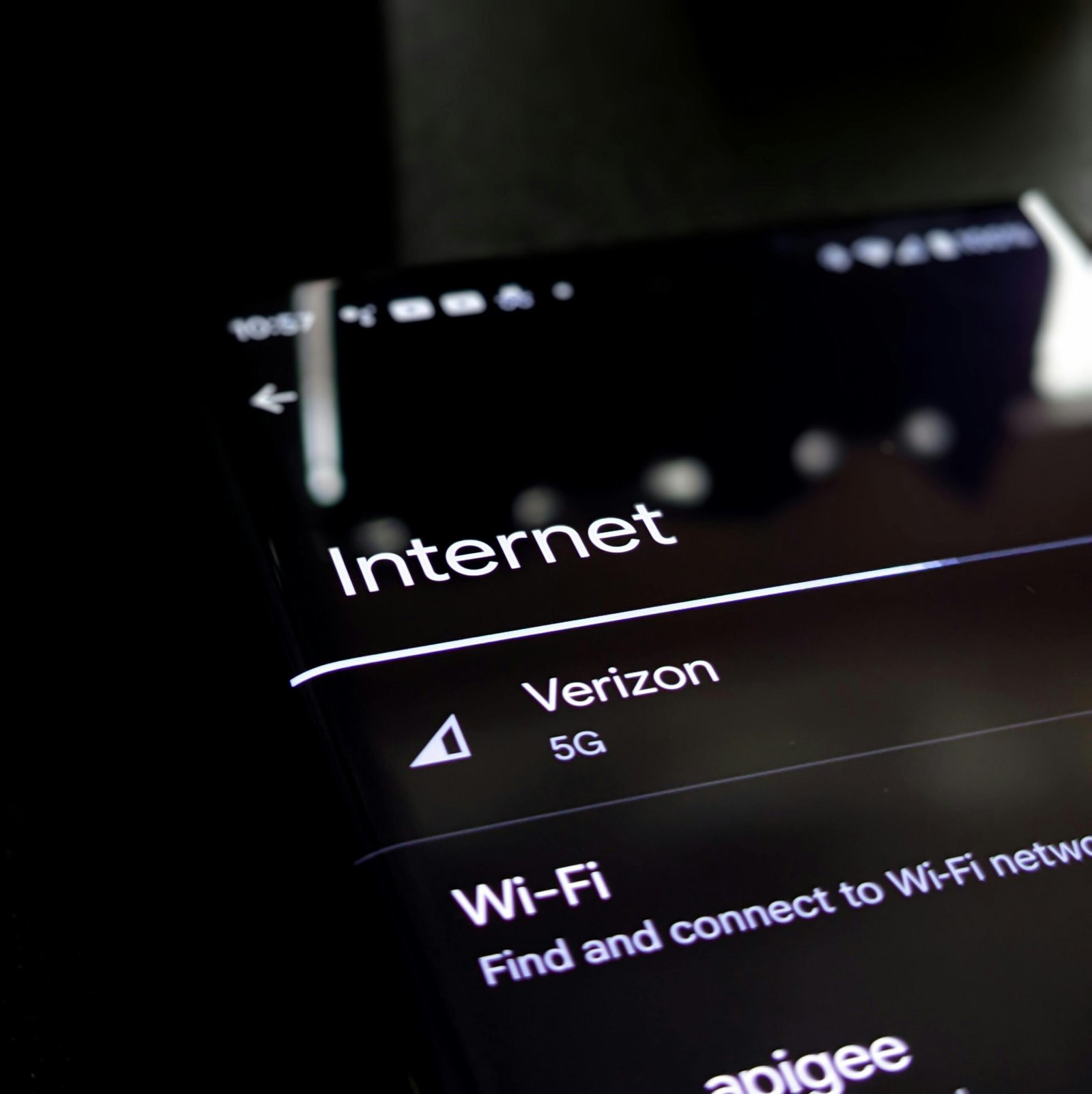 Close-up of a smartphone screen displaying internet connection details with Verizon 5G and Wi-Fi options.