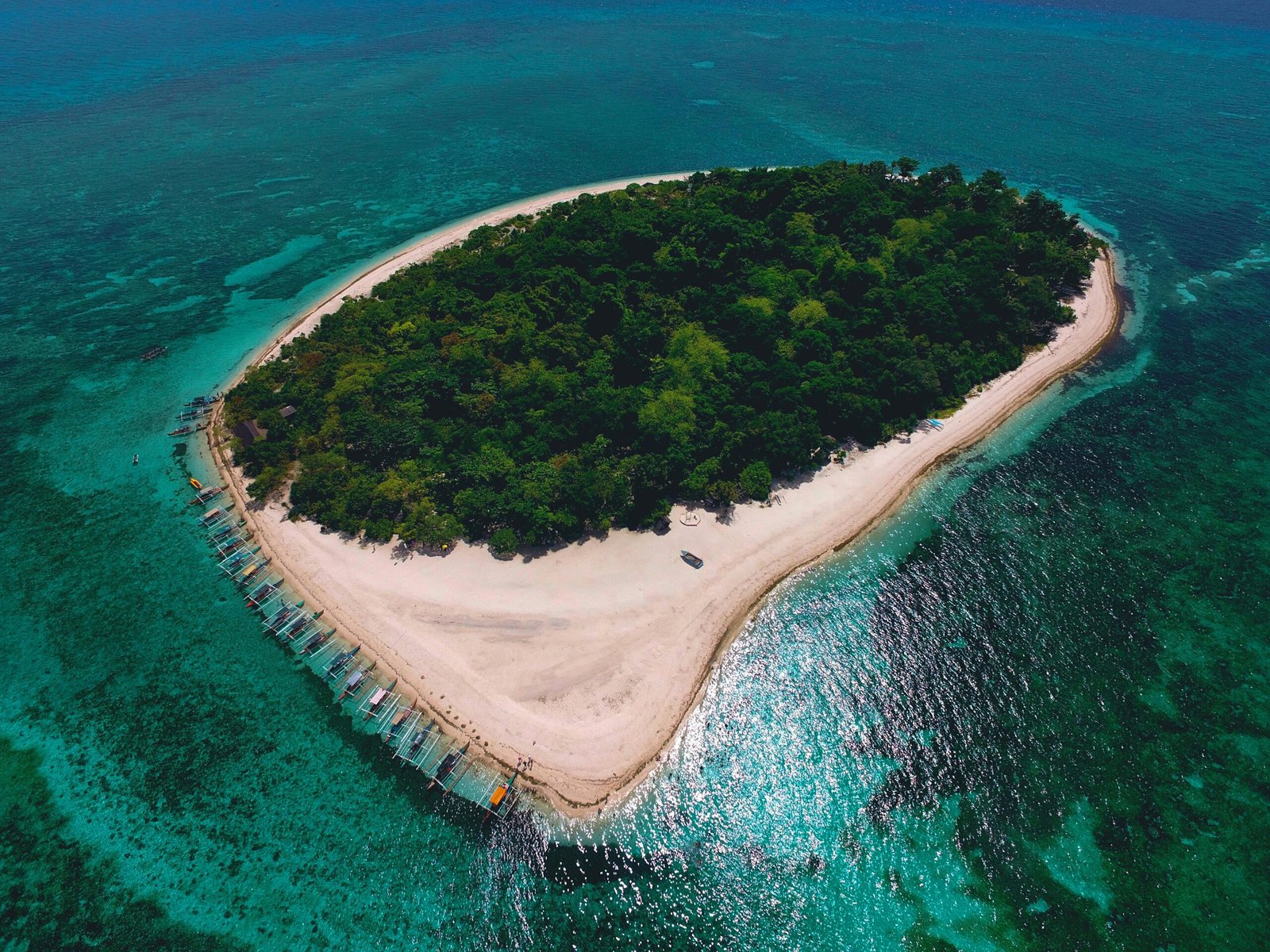 Breathtaking aerial view of a lush tropical island surrounded by azure waters in Northern Mindanao, Philippines.