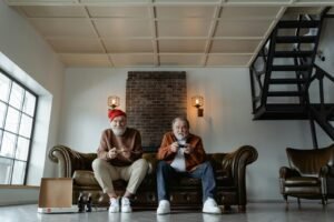 Two senior men enjoying a video game session in a modern living room setting.