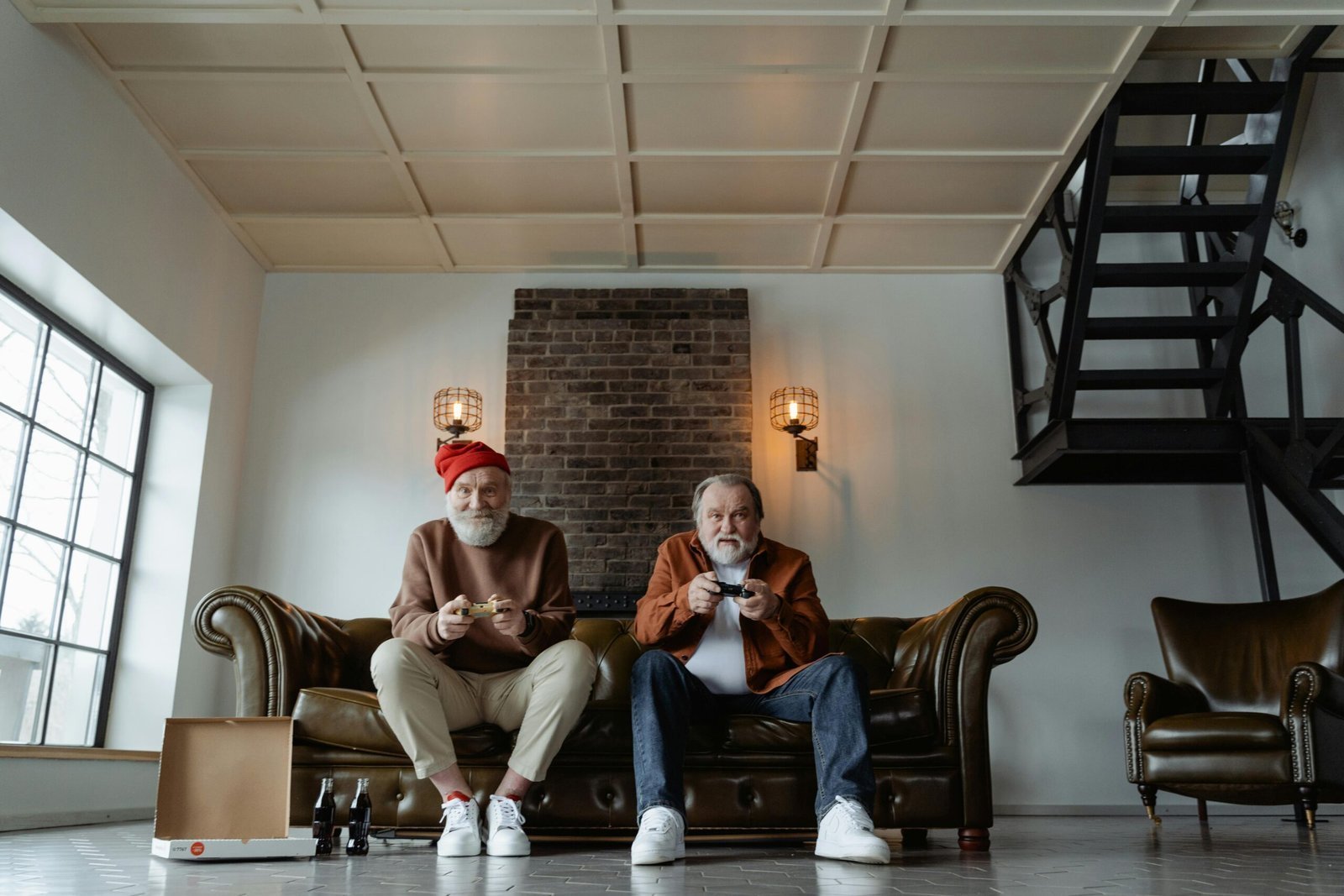 Two senior men enjoying a video game session in a modern living room setting.