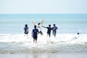 Group of friends playing and enjoying a sunny day at Cox's Bazar beach, Bangladesh.
