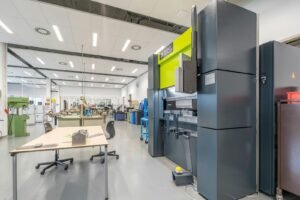 Spacious industrial workshop featuring advanced machinery and organized workstations.