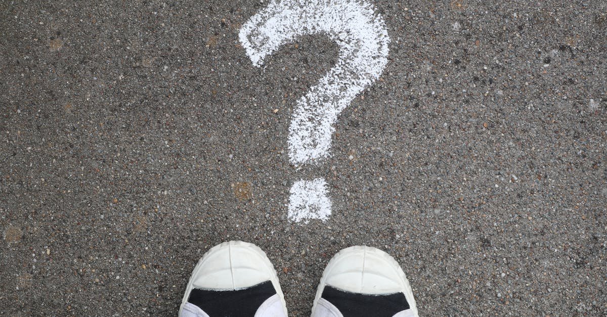 Sneakers on pavement with a chalk question mark, symbolizing curiosity or decisions.