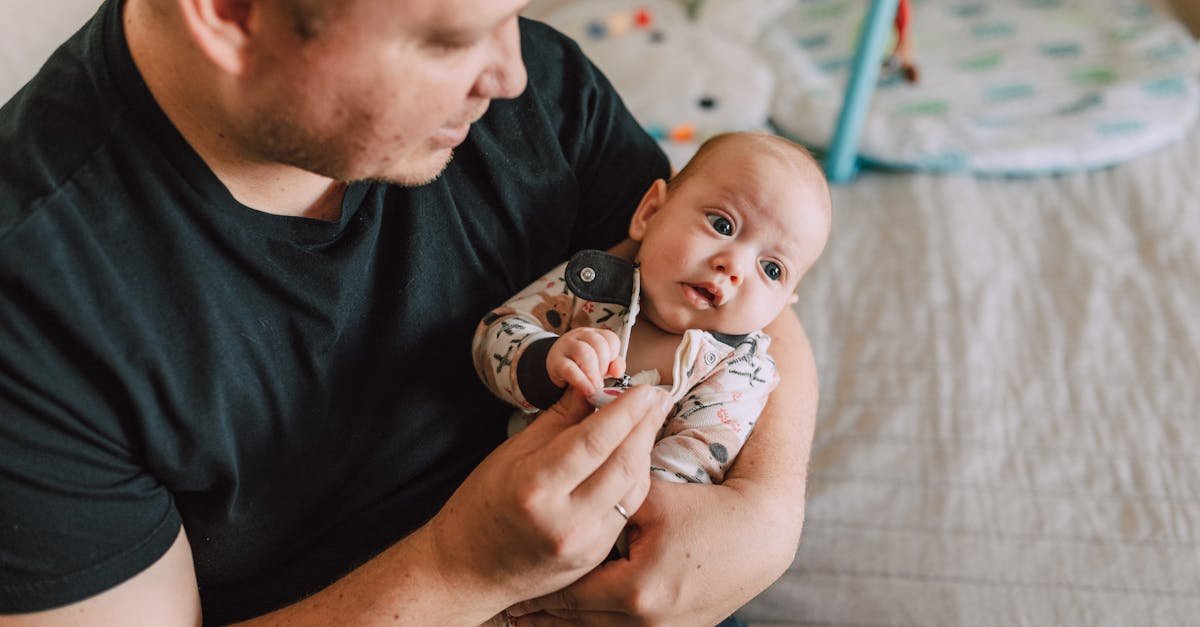 A tender moment between a father and his baby at home, showcasing love and parenting.
