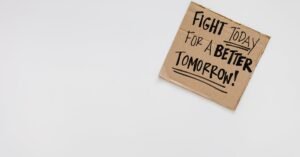 Handwritten motivational message on cardboard for a better future.