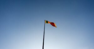A majestic view of the Sri Lankan flag waving against a clear blue sky in Colombo.