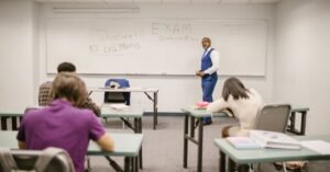 A college educator proctoring an exam, enforcing no cheating rules.