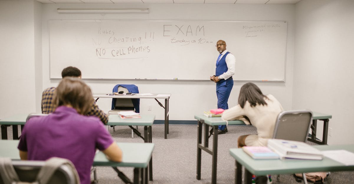 A college educator proctoring an exam, enforcing no cheating rules.