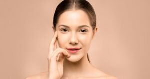 A close-up portrait of a young woman with flawless, radiant skin and a gentle smile, exuding natural beauty.