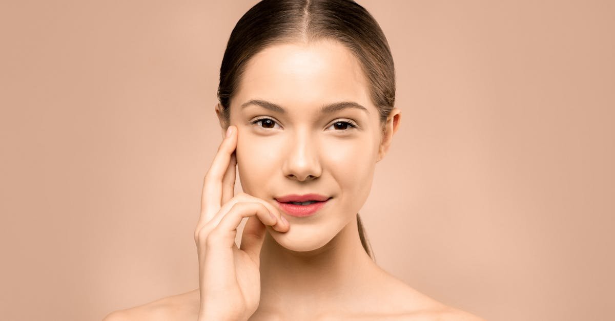 A close-up portrait of a young woman with flawless, radiant skin and a gentle smile, exuding natural beauty.