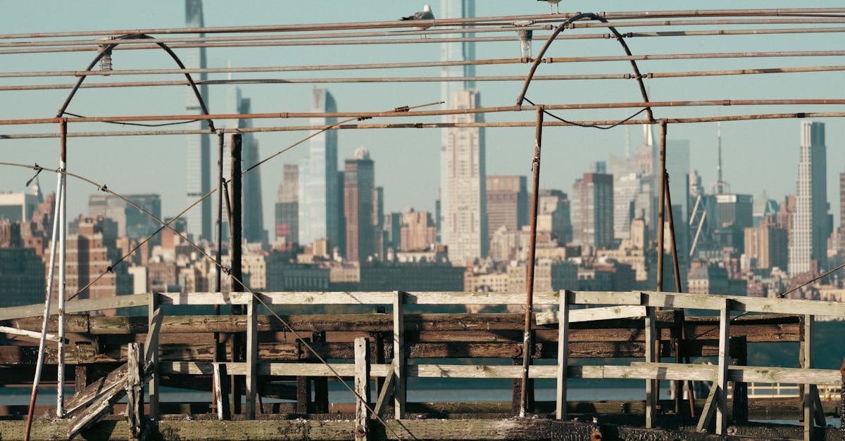 A rustic pier foreground with the vibrant New York City skyline in the background.