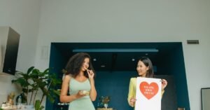 Two women enjoying healthy food and promoting nutrition awareness in a modern kitchen.