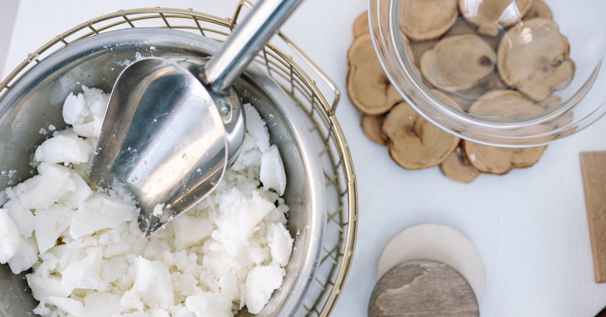 Flatlay of candle wax in a stainless steel bowl with a scooper, perfect for DIY projects.