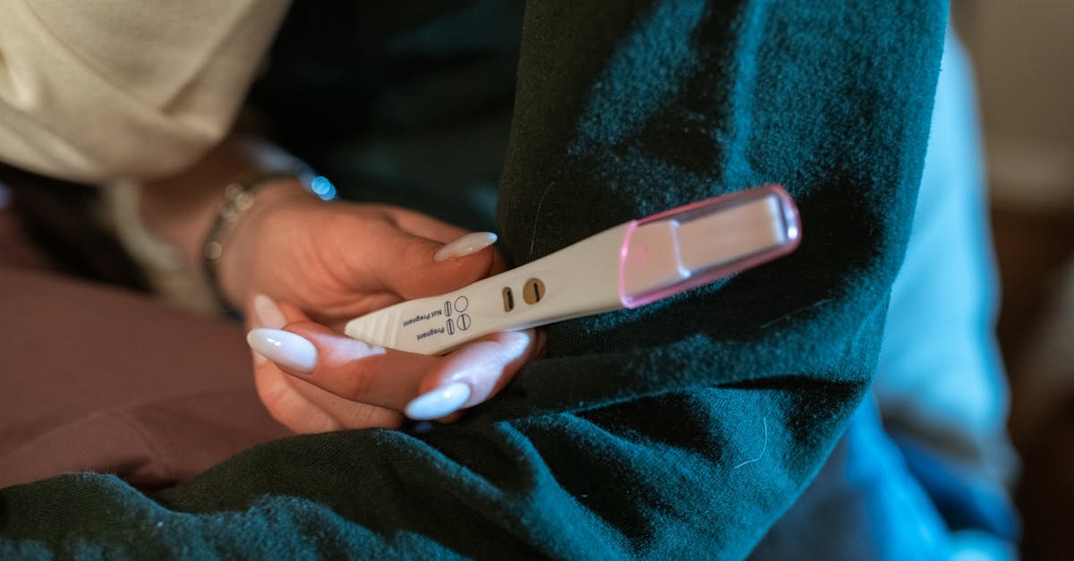A woman's hand holding a positive pregnancy test, symbolizing hope and new beginnings.
