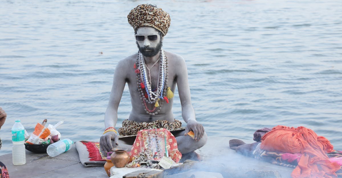 A Sadhu in Varanasi performs a spiritual ritual by the Ganga River, showcasing Indian culture.