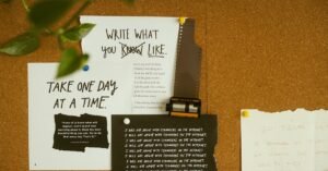 A corkboard with motivational quotes, notes, and film negatives, fostering creativity and reflection.