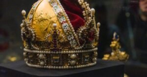 Majestic imperial crown displayed in a Vienna museum, showcasing intricate design and rich history.