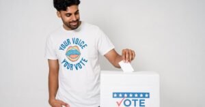 Man casting a vote in an election with a voting ballot box, promoting democratic participation.