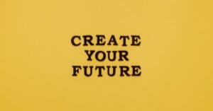 Bold text 'CREATE YOUR FUTURE' on minimalist yellow background. Inspiring design.