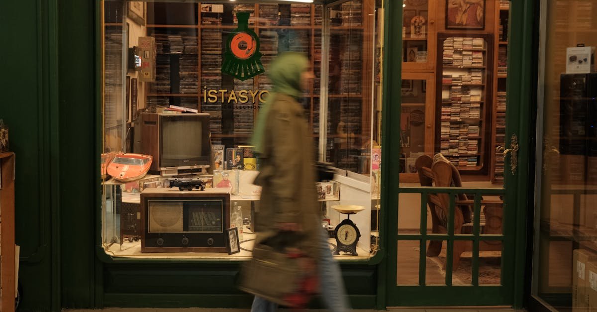 A person walks past a vintage electronics shop with retro displays and a nostalgic atmosphere.