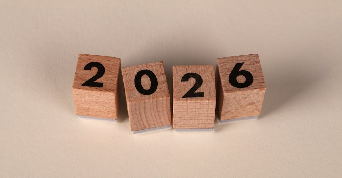 Wooden cubes forming the year 2026 on a neutral background.